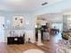 Inviting living room with wood flooring, seamlessly connecting to the dining area for easy entertaining at 2018 E Del Webb Blvd, Sun City Center, FL 33573