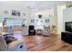 Spacious living room with high ceilings, wood-look flooring, and comfortable seating area at 2018 E Del Webb Blvd, Sun City Center, FL 33573