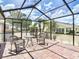 Relaxing screened-in patio offers brick-paved flooring, a spa, and comfortable outdoor seating at 2018 E Del Webb Blvd, Sun City Center, FL 33573