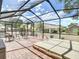 Screened-in lanai with a spa, seating area, and brick-paved patio, perfect for relaxing outdoors at 2018 E Del Webb Blvd, Sun City Center, FL 33573