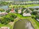 Beautiful aerial view of the home with pond and golf course, community pool, and lush landscaping at 2220 Nantucket Dr # 43, Sun City Center, FL 33573
