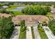 Aerial shot of a house showing its well-manicured lawn, pond, and proximity to lush trees and other houses at 2220 Nantucket Dr # 43, Sun City Center, FL 33573