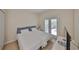 Bright bedroom with tile flooring, a comfortable bed, and access to the outdoors at 2220 Nantucket Dr # 43, Sun City Center, FL 33573