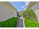 Walkway from the main driveway with lush greenery, leading to the home's front door at 2220 Nantucket Dr # 43, Sun City Center, FL 33573