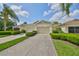 Inviting single-story home with a manicured lawn, mature trees, and a private two-car garage at 2220 Nantucket Dr # 43, Sun City Center, FL 33573