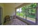 Relaxing screened lanai with patterned floor coverings and a view of the lush green backyard at 2220 Nantucket Dr # 43, Sun City Center, FL 33573