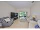 Spacious living room with neutral colors and a view of the lanai at 2220 Nantucket Dr # 43, Sun City Center, FL 33573