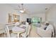 Cozy living and dining room area featuring a ceiling fan, natural light, and comfortable seating at 2220 Nantucket Dr # 43, Sun City Center, FL 33573