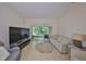 Comfortable living room with neutral color palette, large tv and a lovely outdoor view at 2220 Nantucket Dr # 43, Sun City Center, FL 33573