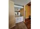 Cozy bar area featuring white cabinets, marble countertop, sink, mirrored backsplash and convenient wine rack at 2704 E Montague E Ct, Clearwater, FL 33761
