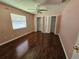 Bedroom with hardwood floors, a fan, a window, and two closets at 2704 E Montague E Ct, Clearwater, FL 33761