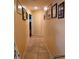 Hallway with tile flooring and framed artwork adorning the peach-painted walls at 2704 E Montague E Ct, Clearwater, FL 33761
