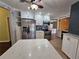 Kitchen with stainless steel appliances, island with quartz countertop, and ample lighting at 2704 E Montague E Ct, Clearwater, FL 33761