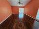 Large living room with hardwood floors, a fan, sliding glass doors to the outside, and a window with blinds at 2704 E Montague E Ct, Clearwater, FL 33761