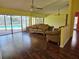 Living room with hardwood floors, leather furniture and pool view at 2704 E Montague E Ct, Clearwater, FL 33761