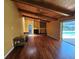 Bright living room with wood floors, wood ceiling, fireplace, and access to outdoor pool area at 2704 E Montague E Ct, Clearwater, FL 33761