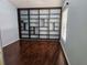 Spacious living room with hardwood floors, light blue walls, a bookshelf and a window with blinds at 2704 E Montague E Ct, Clearwater, FL 33761
