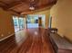 Open-concept living room with hardwood floors, a vaulted ceiling, and a view of the pool outside at 2704 E Montague E Ct, Clearwater, FL 33761