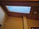Skylight illuminating interior space with wooden ceiling beams and textured walls at 2704 E Montague E Ct, Clearwater, FL 33761
