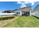 Backyard featuring a trampoline, a covered patio, and a manicured lawn at 28847 Orange Berry Dr, Wesley Chapel, FL 33543
