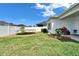 Backyard featuring a trampoline, a grill, and a manicured lawn at 28847 Orange Berry Dr, Wesley Chapel, FL 33543