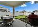 Covered patio featuring a patio table and a grill for outdoor dining and cooking at 28847 Orange Berry Dr, Wesley Chapel, FL 33543