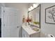 This bathroom features a sleek vanity, framed mirror, and modern decor at 28847 Orange Berry Dr, Wesley Chapel, FL 33543