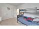 Bedroom featuring a gray bunk bed with spider Personal comforter, two closets and basketball hoop at 28847 Orange Berry Dr, Wesley Chapel, FL 33543