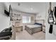 Bedroom featuring a full bed, desk, shelves of decorations, and a guitar on the wall at 28847 Orange Berry Dr, Wesley Chapel, FL 33543