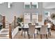 Bright dining room boasts many windows, wood floors, and staircase access at 28847 Orange Berry Dr, Wesley Chapel, FL 33543
