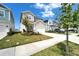 Beautiful two-story home with neutral siding, manicured lawn and spacious driveway leading to a two-car garage at 28847 Orange Berry Dr, Wesley Chapel, FL 33543