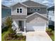Charming two-story home featuring a manicured lawn, neutral siding, stone accents and a spacious two-car garage at 28847 Orange Berry Dr, Wesley Chapel, FL 33543