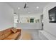 Cozy upstairs hallway with a ceiling fan, TV, and modern furniture at 28847 Orange Berry Dr, Wesley Chapel, FL 33543