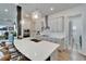 Bright kitchen featuring white cabinets, stainless steel appliances, and a center island at 28847 Orange Berry Dr, Wesley Chapel, FL 33543