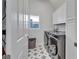 Clean, bright laundry room with modern appliances and stylish tile flooring at 28847 Orange Berry Dr, Wesley Chapel, FL 33543