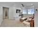 Cozy upstairs living room with a ceiling fan, TV, and modern furniture at 28847 Orange Berry Dr, Wesley Chapel, FL 33543