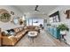 Beautiful living room features a large leather sectional and ample natural light at 28847 Orange Berry Dr, Wesley Chapel, FL 33543