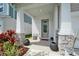 Inviting front porch featuring stone accents, stylish seating, decorative plants and a welcoming entrance at 28847 Orange Berry Dr, Wesley Chapel, FL 33543