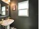 Modern powder room with a stylish vanity, sleek faucet, and decorative accents at 28847 Orange Berry Dr, Wesley Chapel, FL 33543