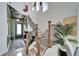 Staircase with wood railing and an exterior door at 28847 Orange Berry Dr, Wesley Chapel, FL 33543