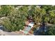 Aerial view of cozy home featuring lush, mature trees providing plenty of shade at 3020 E Louisiana Ave, Tampa, FL 33610