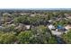 An aerial shot showing the neighborhood with mature trees and the Tampa skyline in the distance at 3020 E Louisiana Ave, Tampa, FL 33610