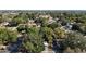 Aerial view of neighborhood with mature trees with view of Tampa Bay at 3020 E Louisiana Ave, Tampa, FL 33610
