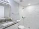 Updated bathroom features modern shower with textured tile and a granite-topped vanity at 3020 E Louisiana Ave, Tampa, FL 33610