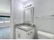 Well-lit bathroom features granite countertop, mirror, and modern fixtures at 3020 E Louisiana Ave, Tampa, FL 33610