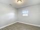Bedroom with gray wood-look tile, and a window that provides ample natural light at 3020 E Louisiana Ave, Tampa, FL 33610
