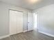 Bedroom with closet, gray wood-look tile, and neutral walls at 3020 E Louisiana Ave, Tampa, FL 33610