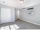 Bedroom featuring a split unit AC, closet and wood-look tile at 3020 E Louisiana Ave, Tampa, FL 33610