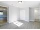 Spacious bedroom features gray wood-look tile, closet, and an ensuite bathroom at 3020 E Louisiana Ave, Tampa, FL 33610