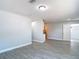 Well-lit bedroom featuring gray wood-look tile and neutral walls at 3020 E Louisiana Ave, Tampa, FL 33610